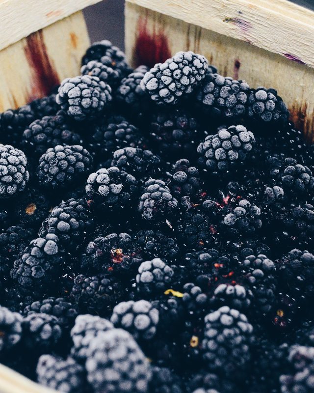 A basket of dark, ripe berries